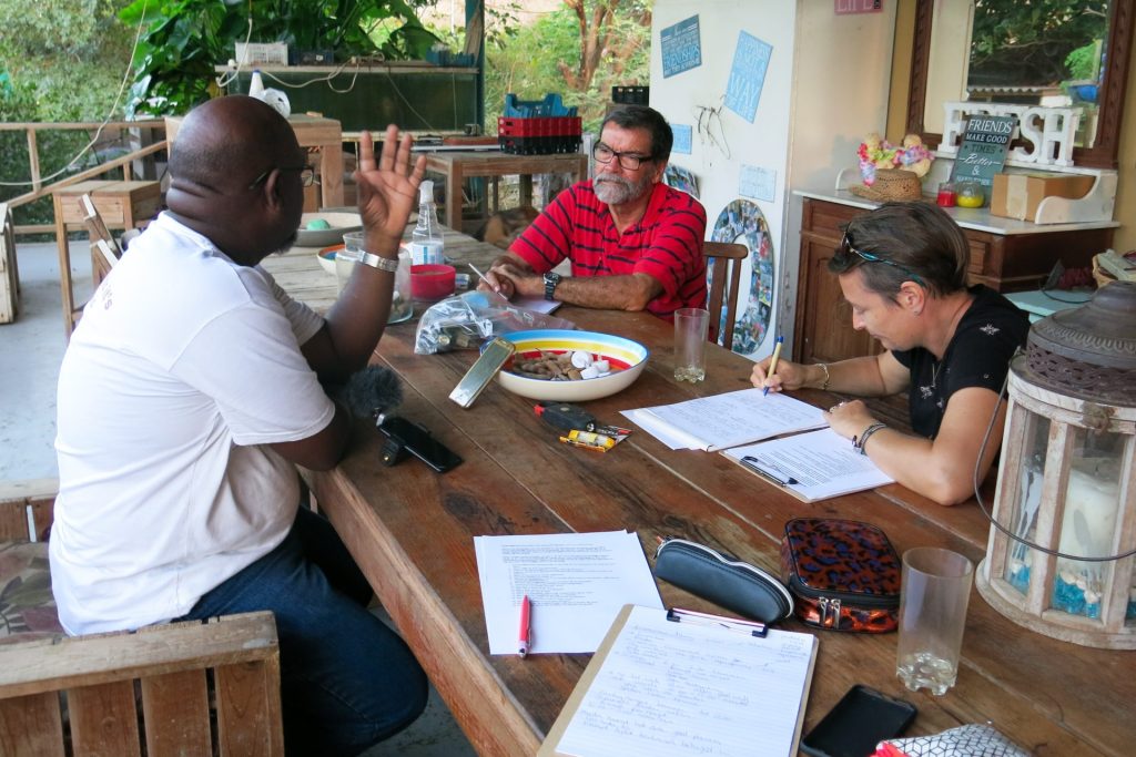 Meeting between three people, one person is writing